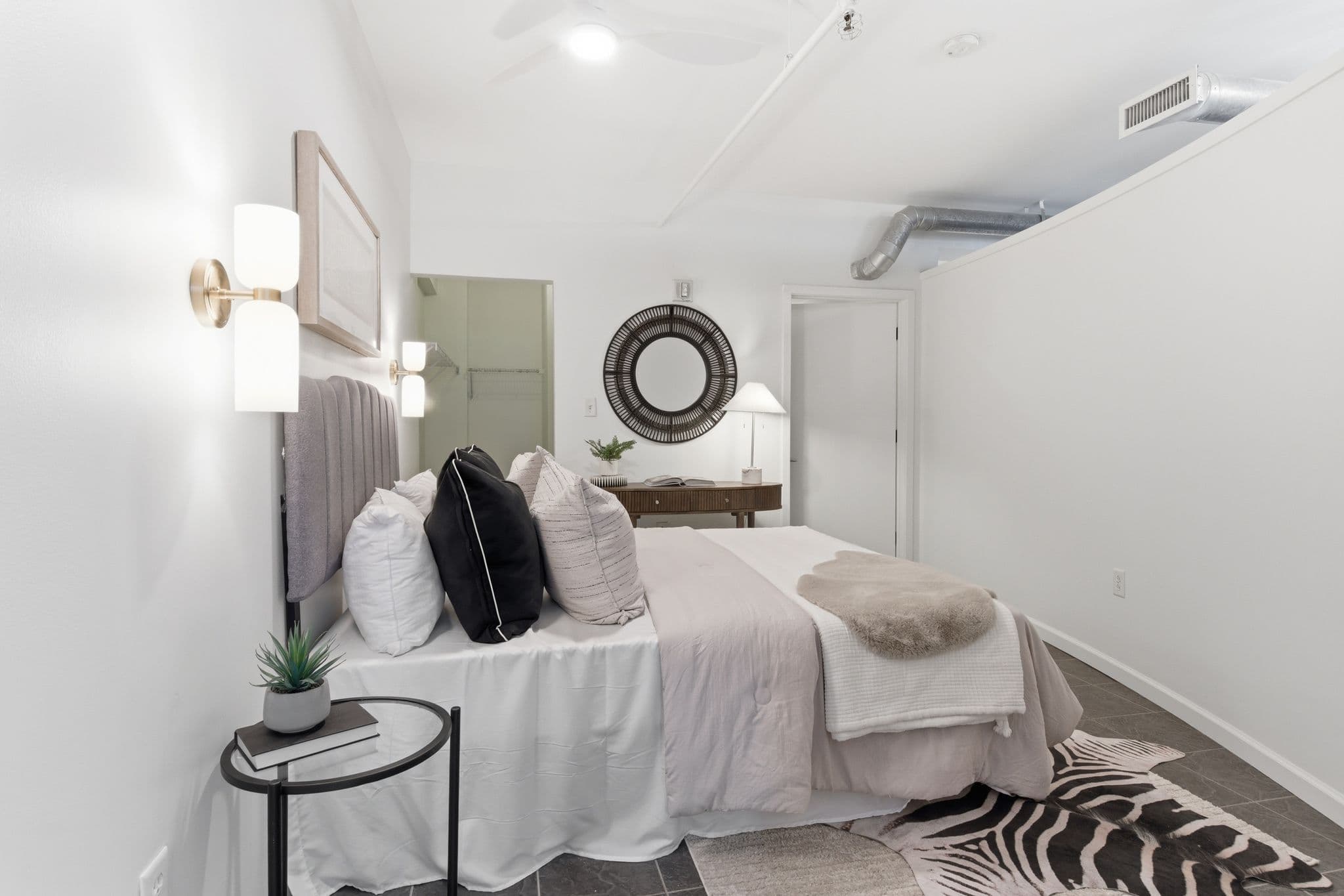Modern bedroom with painted white walls and ceiling, gray headboard, Nashville
