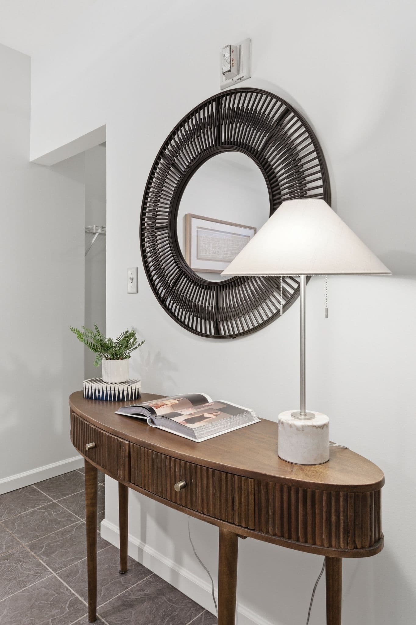 Entryway console table and round mirror against newly painted walls